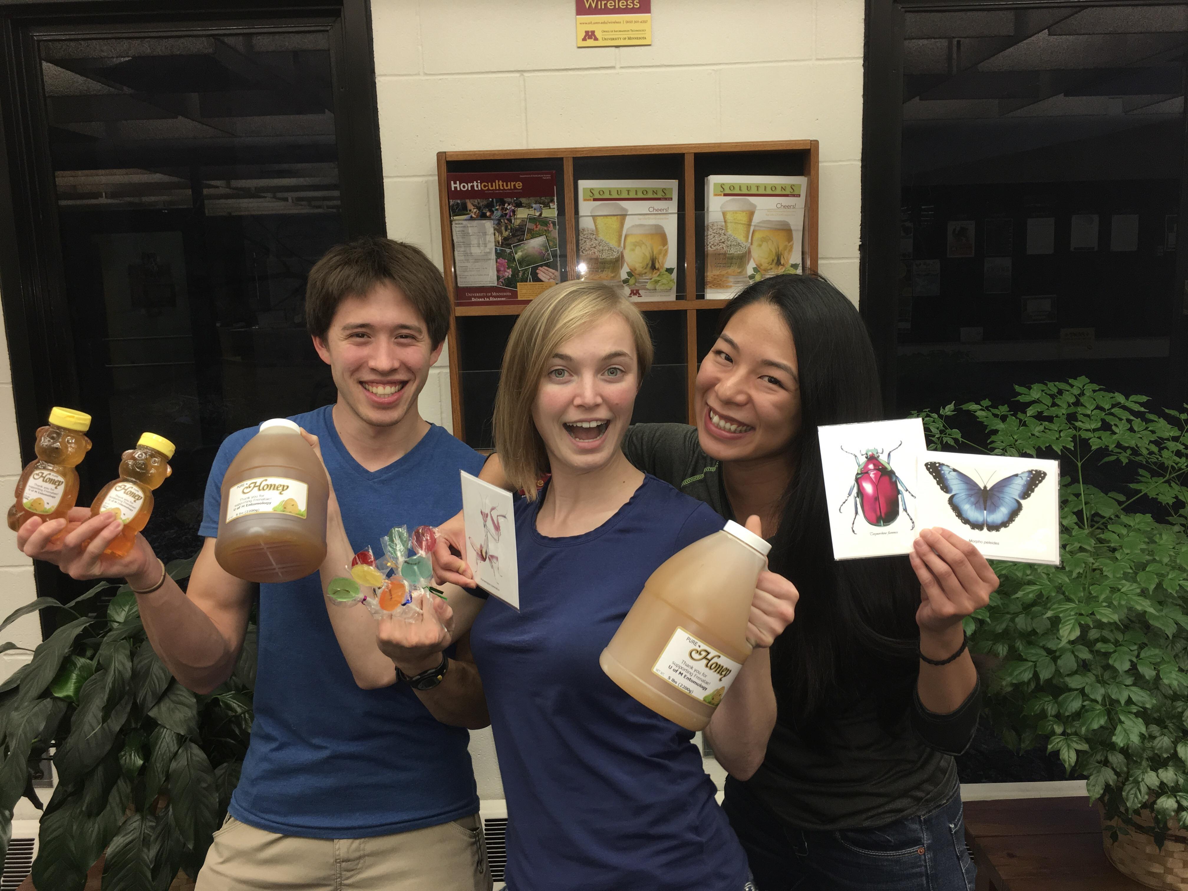 Graduate students Eric Middleton (PhD, Heimpel & Macrae labs), Grace Sward (MS, Philips lab), and Anh Tran (PhD, Hutchison lab) get ready for the annual Frenatae Honey Sale!